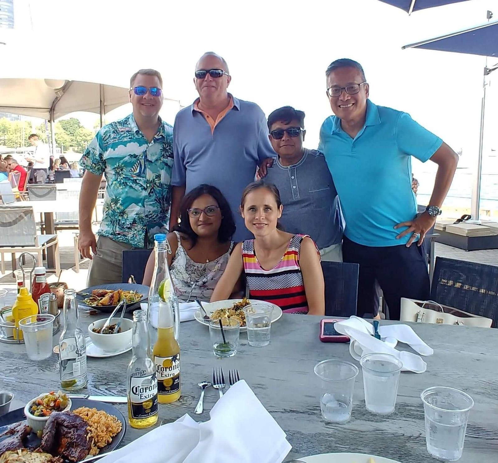 ISG teammates at a dockside lunch during a summer outing